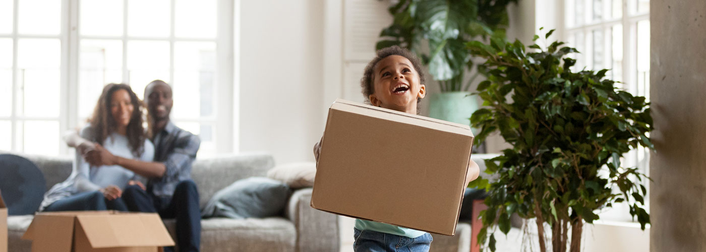 Couple and child moving into a new home
